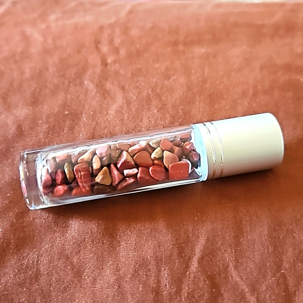 Empty glass roll on bottle with Red Jasper chips inside